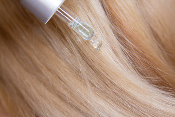 Fototapeta premium Beautiful Hair. background. Beauty Healthy blond Hair. shiny straight hair. Hairstyle. Hair cosmetics. Damage hair Health of hair