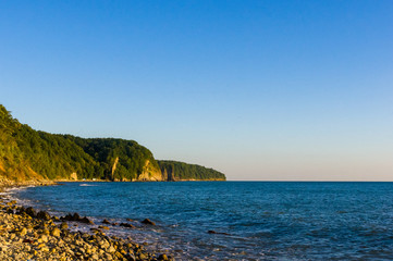sea landscape is a pebbly beach with waves in white foam