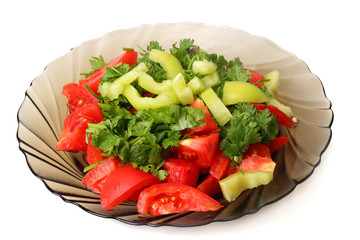 plate of tomato and pepper salad isolated on white
