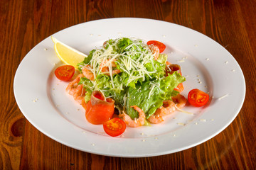 Caesar salad with shrimps and salmon