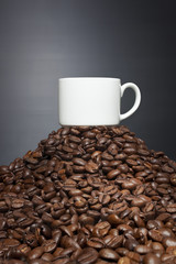 Coffee cup in top of the coffee beans
