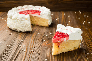 Strawberry Cake dessert with candies on wooden background