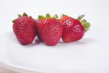 Fresh strawberries on a white plate