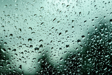 Rain drops on the car glass. Blurred background. Bokeh
