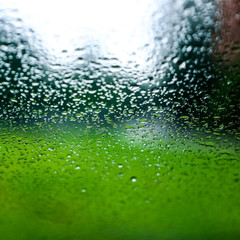 Rain drops on the car glass. Blurred background. Bokeh