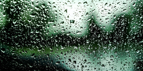 Rain drops on the car glass. Blurred background. Bokeh