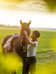 Gordijnen Jonge vrouw met haar paard bij zonsopgang. © Lukas Gojda