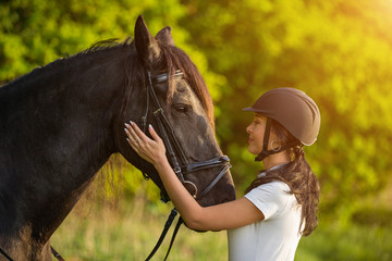 Young Woman with her horse at sunrise.