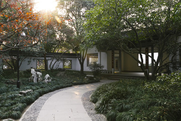 Path leading to a traditional Chinese house in a park