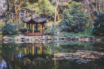 Traditional Chinese pavilion by a pond