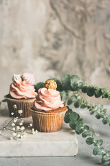 Cupcakes with buttercream on marble board. Luxury wedding or birthday cupcakes. Toned image