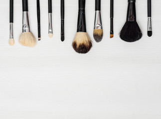 make-up brushes on a light  background