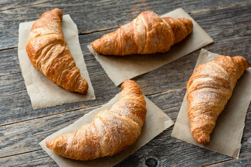 Freshly baked croissants on wooden table