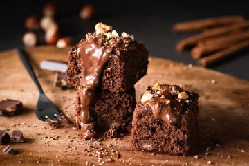 Gordijnen Chocolate Cake Brownie Squares With Chocolate Glaze and Walnuts. Closeup view, selective focus © Vladislav Noseek