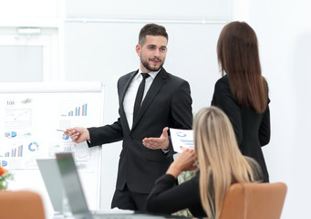 businessman makes a presentation to his business team