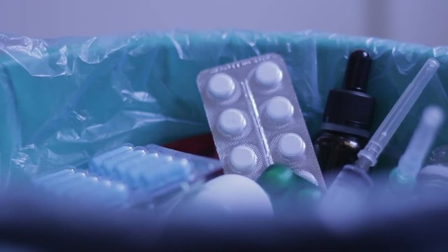 Junkie decides to stop eating pills, getts rid of drugs, throwing into trash can