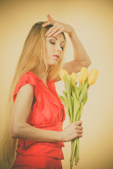 Pretty woman with yellow tulips bunch