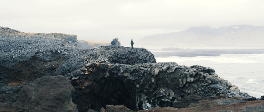 Woman overlooking scene at Vik, Iceland.