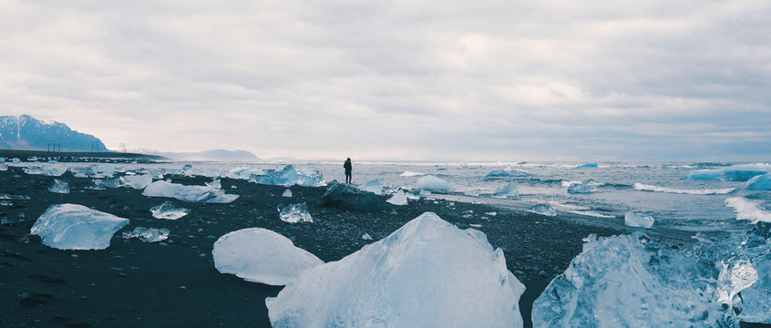 Woman alone at Diamond Beach, Iceland.  