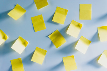 A lot of Blank Yellow stickers with no inscription on a white fridge. Yellow note on fridge. Concept of reminder, alarm. Leaving a message for someone on the fridge.