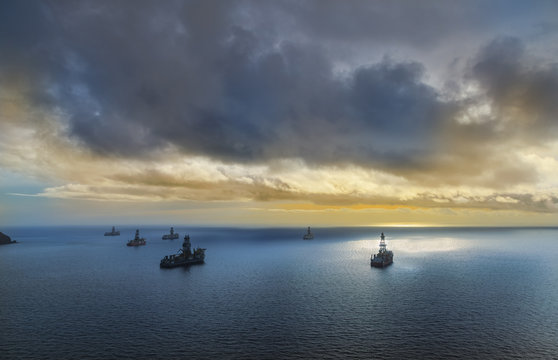 Cargo tankers ships on Mediterranean sea at sunset. Tenerife seacoast of Spain