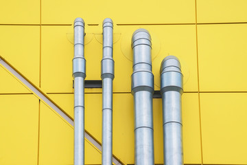 Metal pipes on the yellow wall