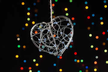 Heart shaped metal cage on bokeh light background
