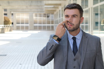 Businessman picking his nose in office space