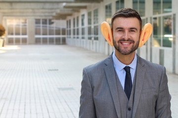 Big-eared businessman smiling in office space