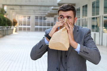 Man suffering an unpleasant smell at work  