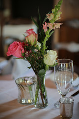 Wedding Reception Table Decorated with Silver and a Pink, White, and Green Centerpiece of Roses