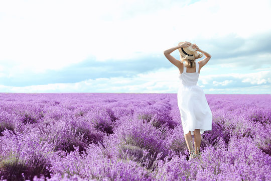 Young Woman In Lavender Field On Summer Day