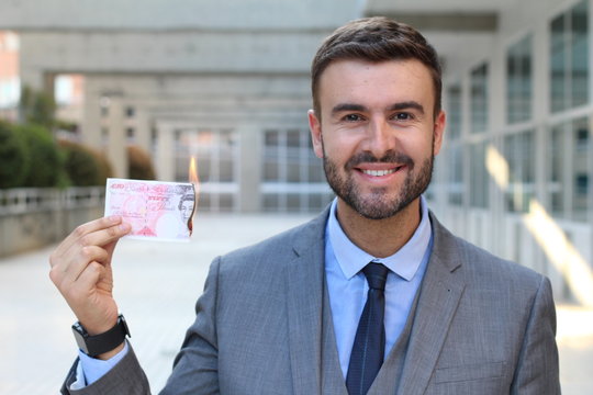 Businessman Burning Twenty Pound Note