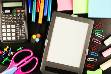 School equipment with staionery, chalk, calculator, tablet and other