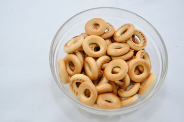 Drying, dry bagels, sweet cake, in plates. On a white background
