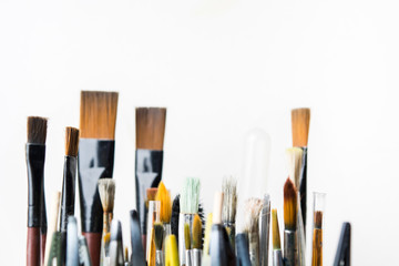 Fototapeta premium Used colorful creative brushes for painting arts with white background