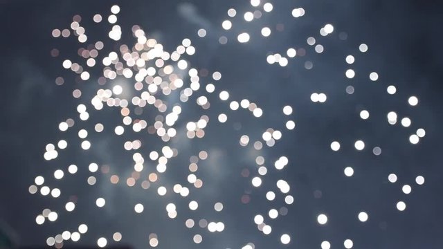 Reverse abstract conceptual footage of kid silhouette watching the reverse implosion of multiple fireworks burst during national holiday 4k uhd video