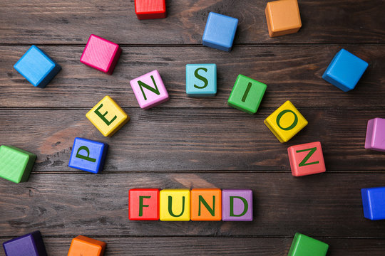 Colorful cubes with text PENSION FUND on wooden background