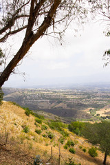 Landscape view of the surrounding area from the top of the hill overlooking a cityscape in the distance