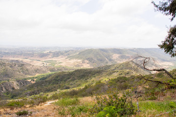 Finding peace and quiet on lonely hiking trails and enjoying the landscape views from the top of the hill overlooking a city in the distance.