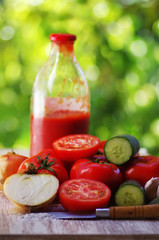 ripe tomatoes and glass bottle of tomato paste