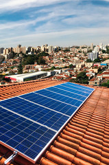 Photovoltaic power plant on the roof of a residential building on sunny day - Solar Energy concept of sustainable resources © Andre Nery