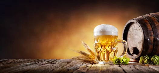Foto auf Acrylglas Bier Bierkrug mit Weizen und Hopfen im Keller mit Fass