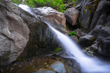 Naklejka na ściany i meble Large boulders and Rushing Falls in Mountain Stream Along Ebbetts Pass