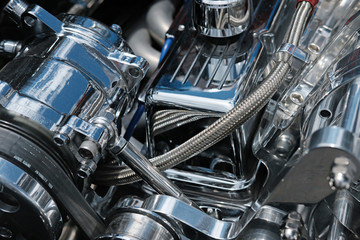 Close up of Chrome Engine Parts, Hoses and Belts on a High Performance Engine