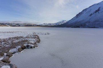 Scenic View Of Frozen Lake And Mountains Against Mountain