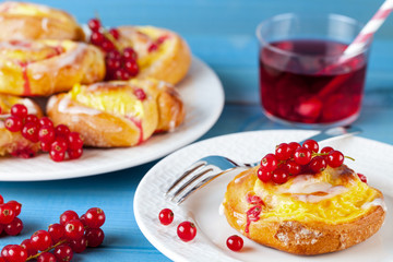 Pudding Schnecken Kuchen mit Johannisbeeren Obst auf Holz Hintergrund türkis