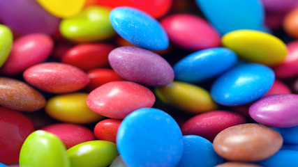 Fototapeta na wymiar Macro closeup of multi color candy and jellies, colorful background.