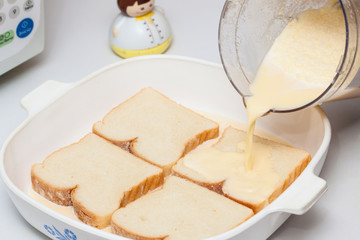 French toast preparation: Soaking bread in the mix for french toast preparation