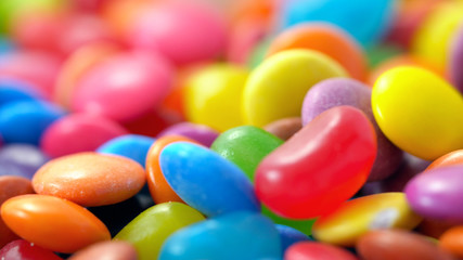 Macro closeup of multi color candy and jellies, colorful background.